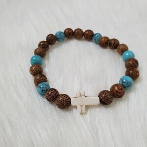 ESSENTIAL CHARMS white cross design stretch bracelet with wood and turquoise bea
